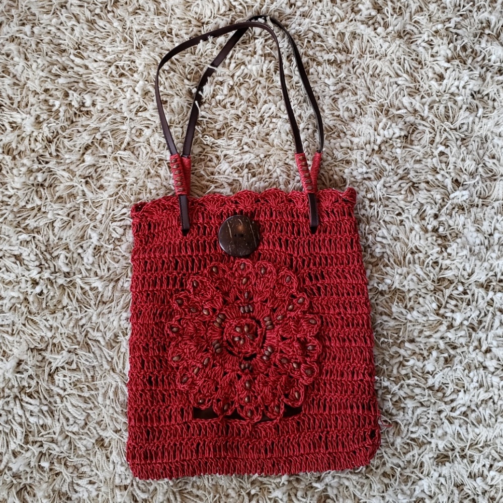 Red woven Maluca handbag with brown beads.